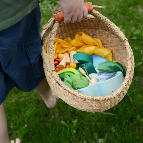 Natural colored bolga basket full of colorful playsilks 