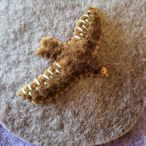 An applique bird on the pocket of a handmade waldorf wool felt advent calendar