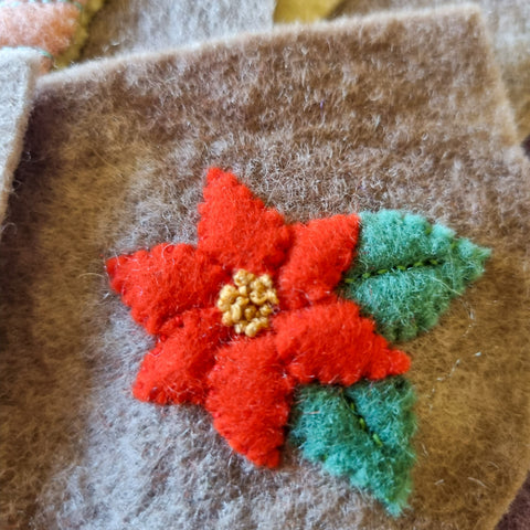 applique poiensetta flower on a handmade waldorf wool felt advent calendar