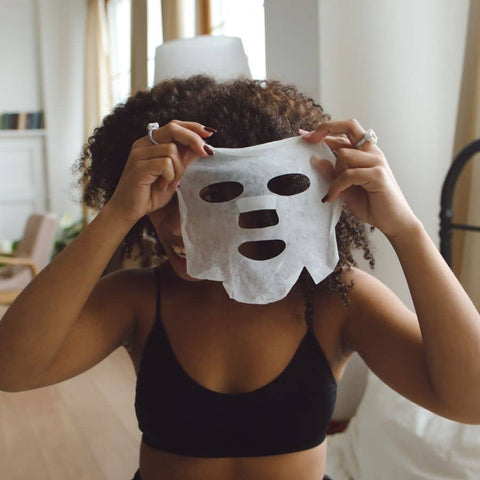 woman placing a facial sheet mask hydrating restoring renewing Patchology