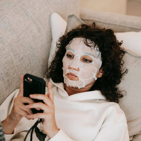 woman wearing sheet mask to retore and renew