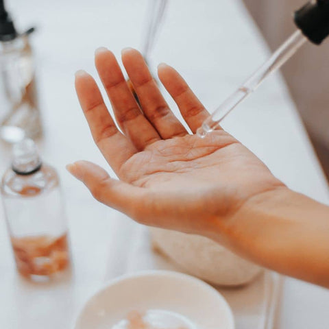 serum application close up in hands to restore skin after a day in the sun