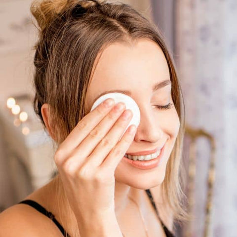 woman removing makeup toner twice per day