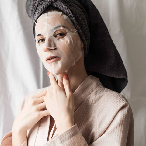 woman wearing hydrating patchology sheet mask prep skincare to shine this summer without makeup