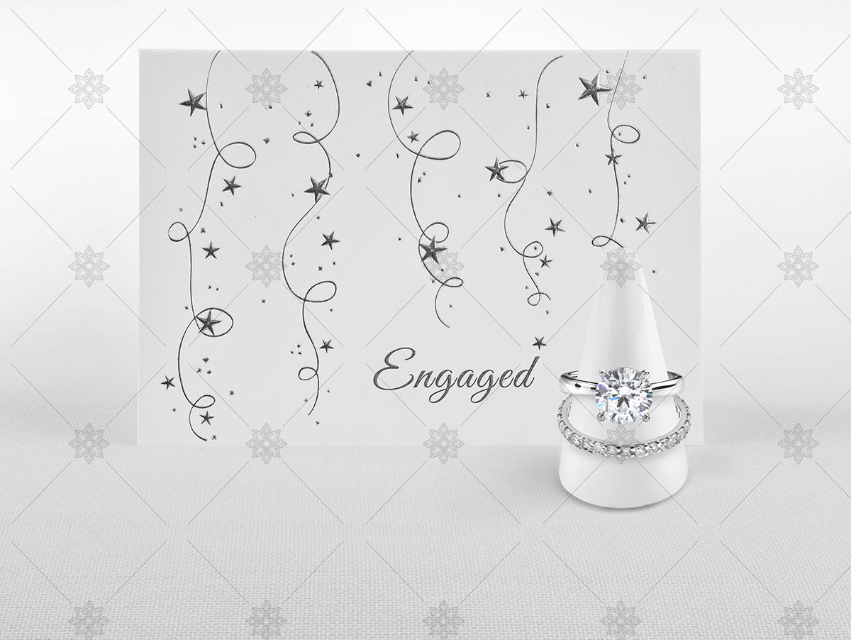 engaged card and diamond rings