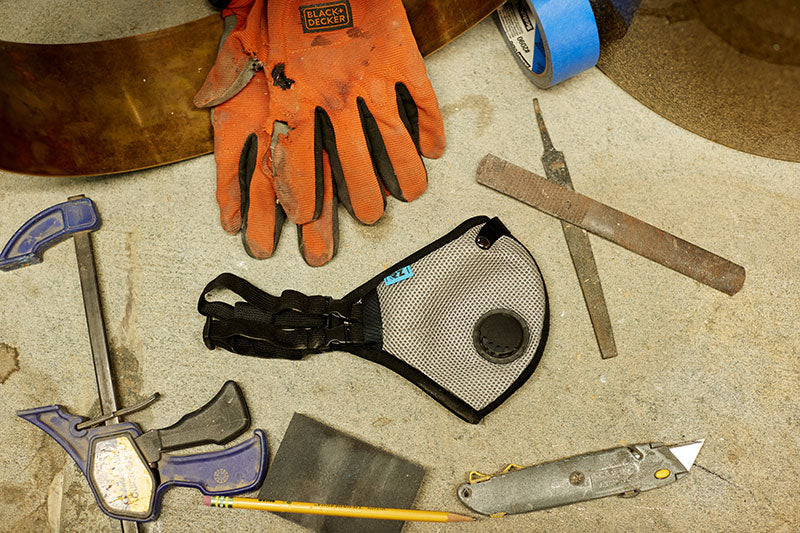 Various tools on table with RZ dust mask centered