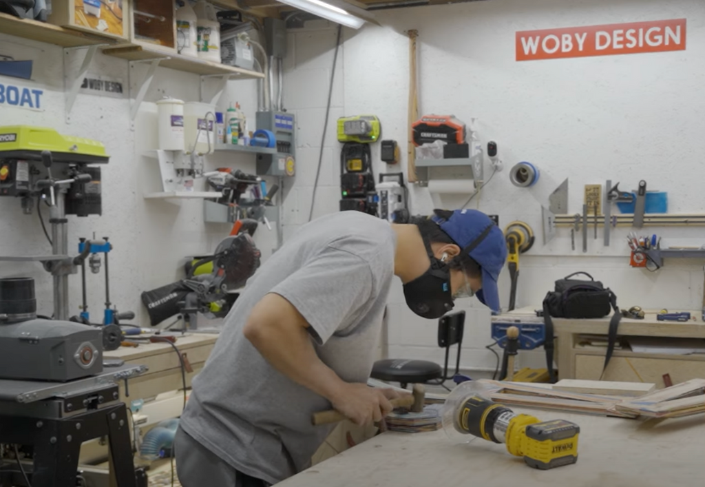 Woby sanding wood while wearing an M2.5 Mask