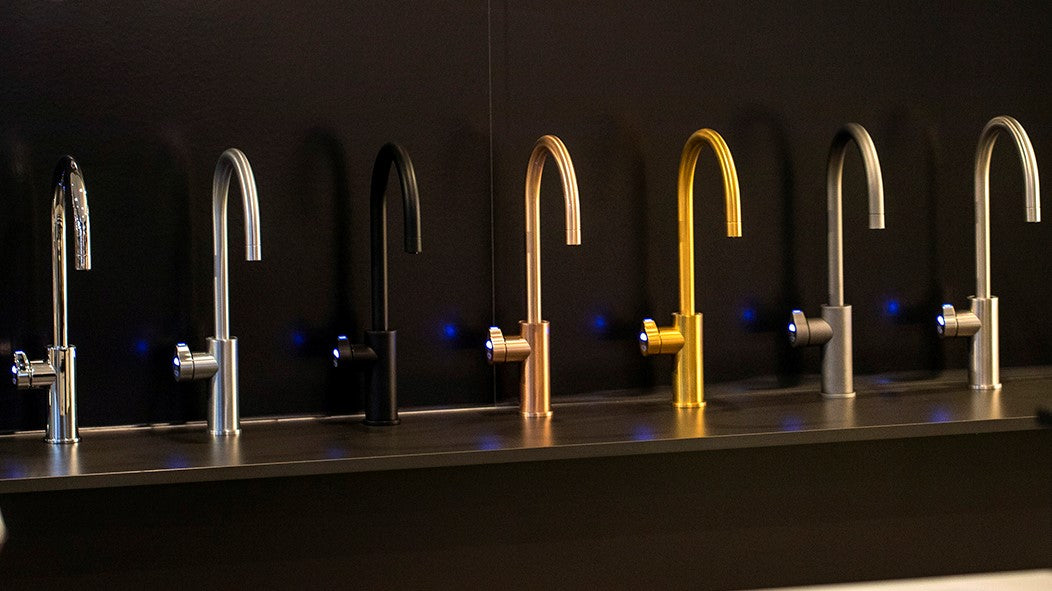 Showroom displays of sink mixers in a variety of colours and finishes