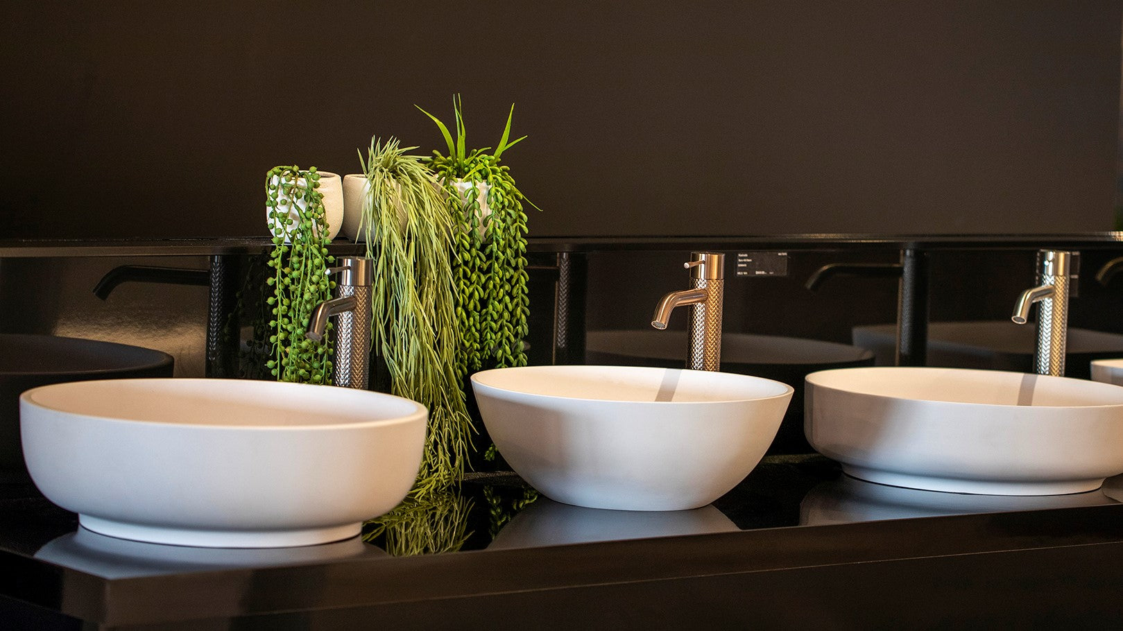 Showroom displays of above counter bathroom sinks and tapware