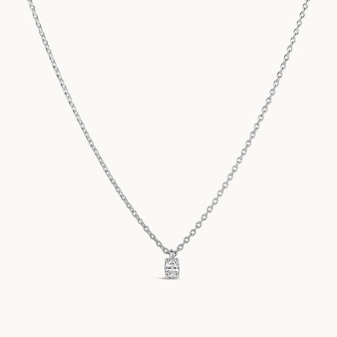 small and dainty oval diamond pendant on a solid white gold chain