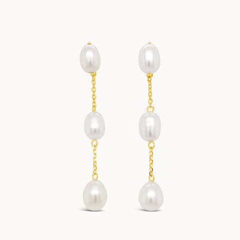 Pearl drop earring featuring three small, natural pearls along a yellow gold chain