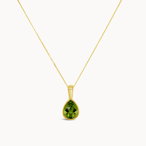 Green peridot teardrop shape necklace set in yellow gold on a dainty yellow gold chain