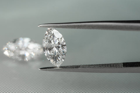 Marquise cut diamond held in a jewellers tweasers