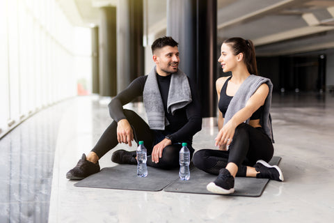 man and woman having a conversation after a workout