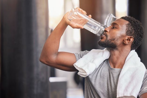 Man drinking water after workout