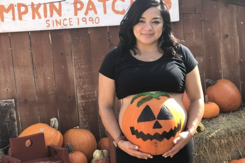 ic:Pumpkin Face Painted on Baby Bump for Hallloween