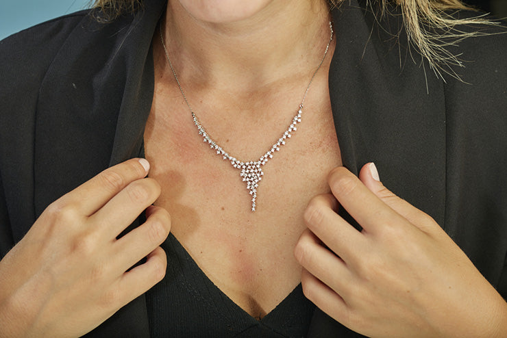 a woman wearing a diamond chain necklace