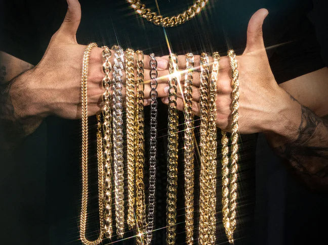 holding gold chain necklaces