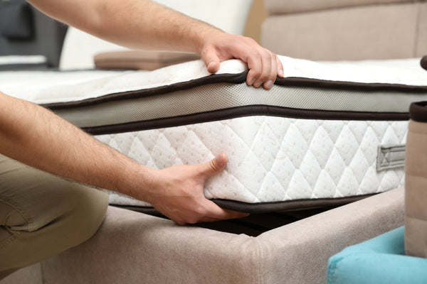 Young man ensuring optimal sleep by selecting the right mattress emphasizing the importance of sleep environment and bedtime routine