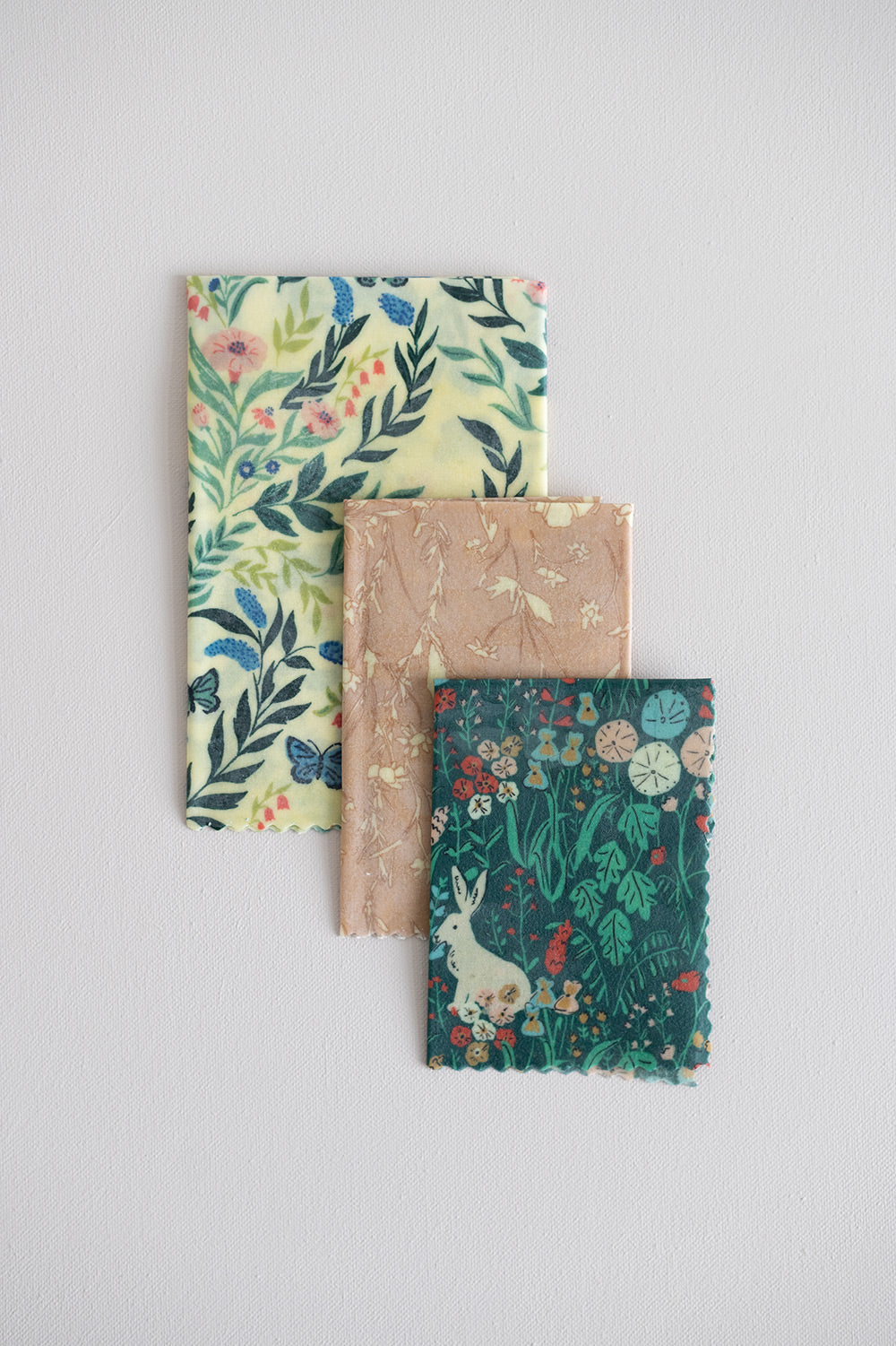 A variety pack of 3 different garden inspired patterned beeswax wrap overlaying from largest to smallest.