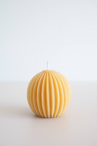 Natural beeswax fluted sphere candle