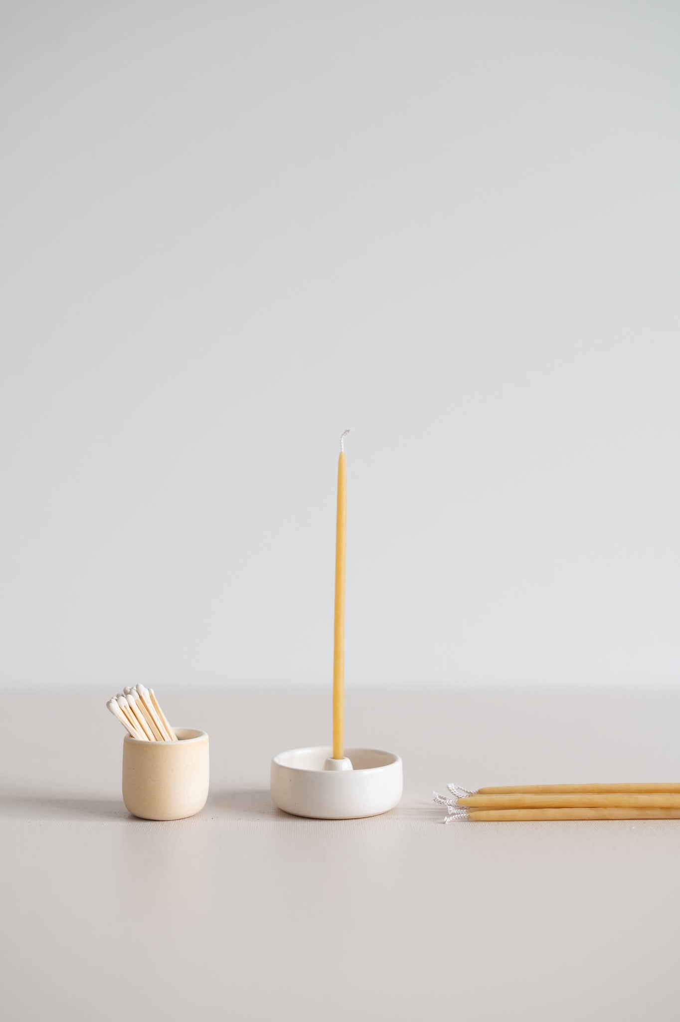 Natural gala candle on a mini candle holder with match striker