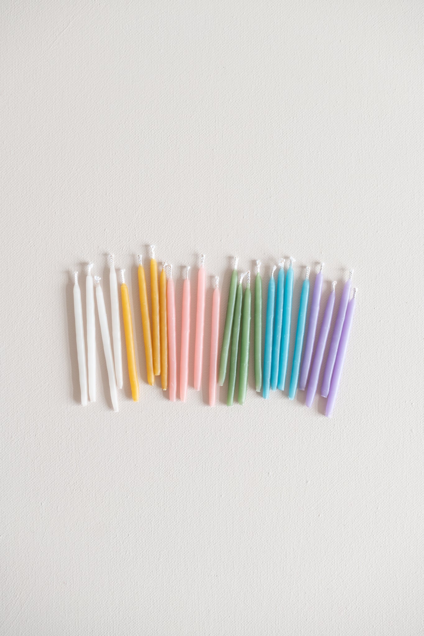 beeswax candles in pastel and natural