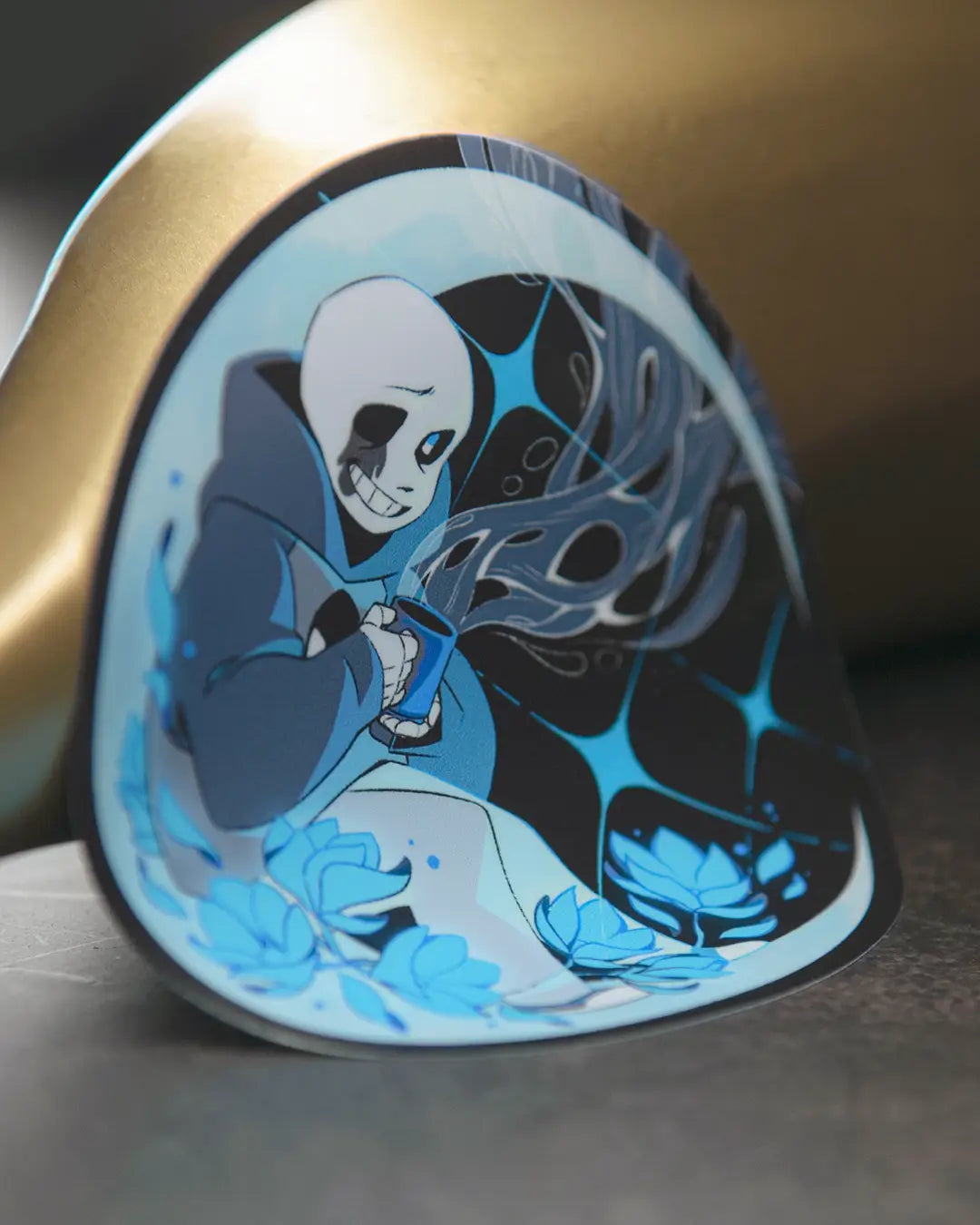 Fan art of Sans while he drinks a cup of coffee. Sticker printed by Rockin Monkey