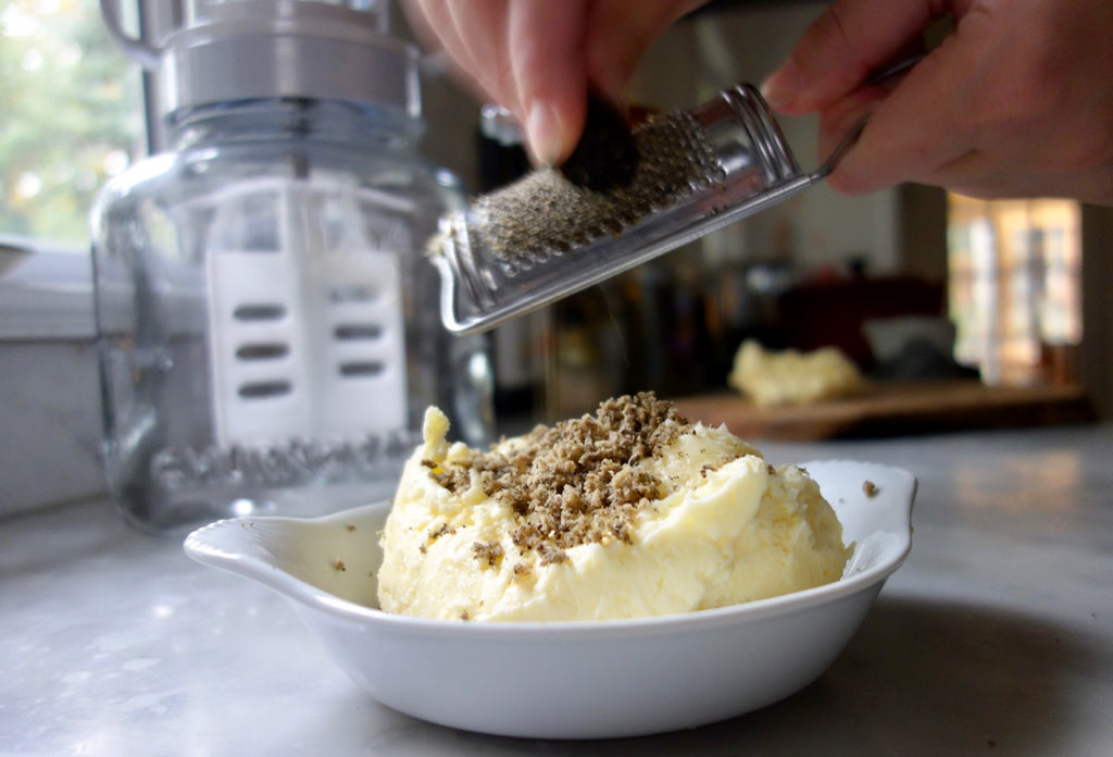 Grating truffles on homemade butter