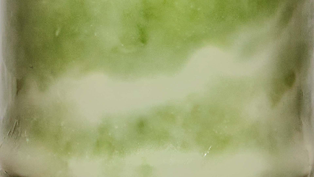 close up of matcha latte in clear glass