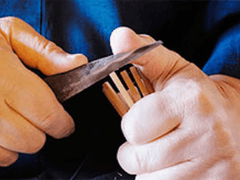 Person using a knife to trim the edges of the sliced bamboo