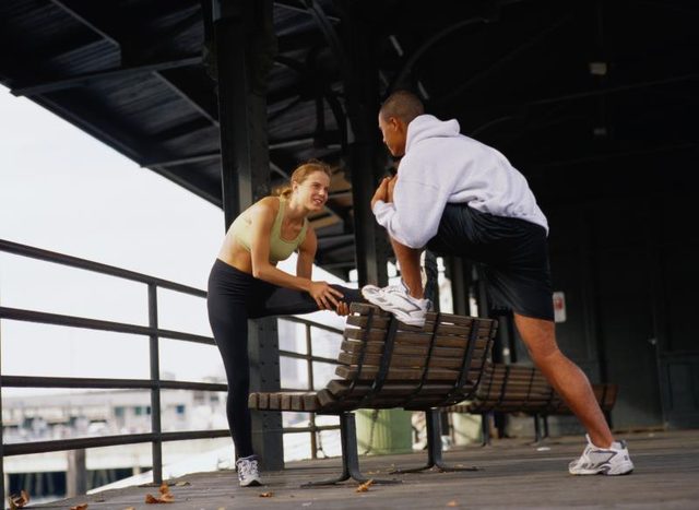 A man and woman stretching.