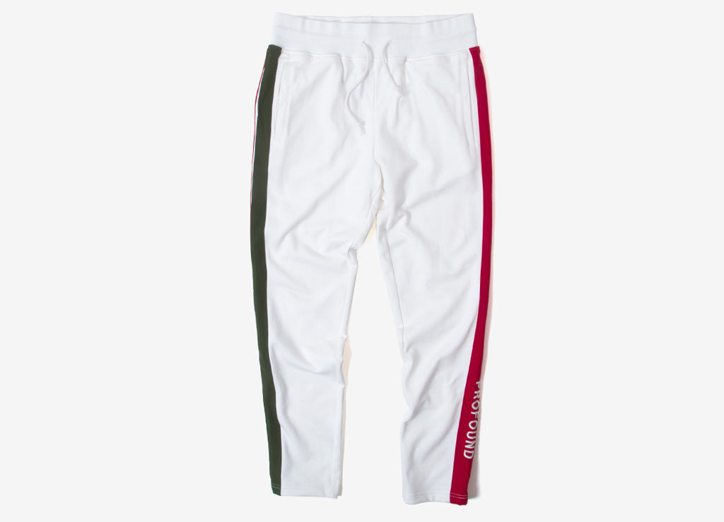 green track pants with red stripe