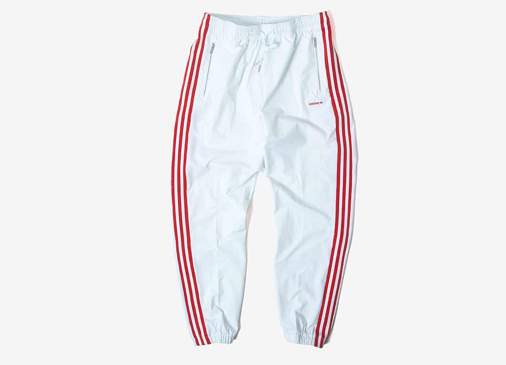white adidas track pants with red stripes