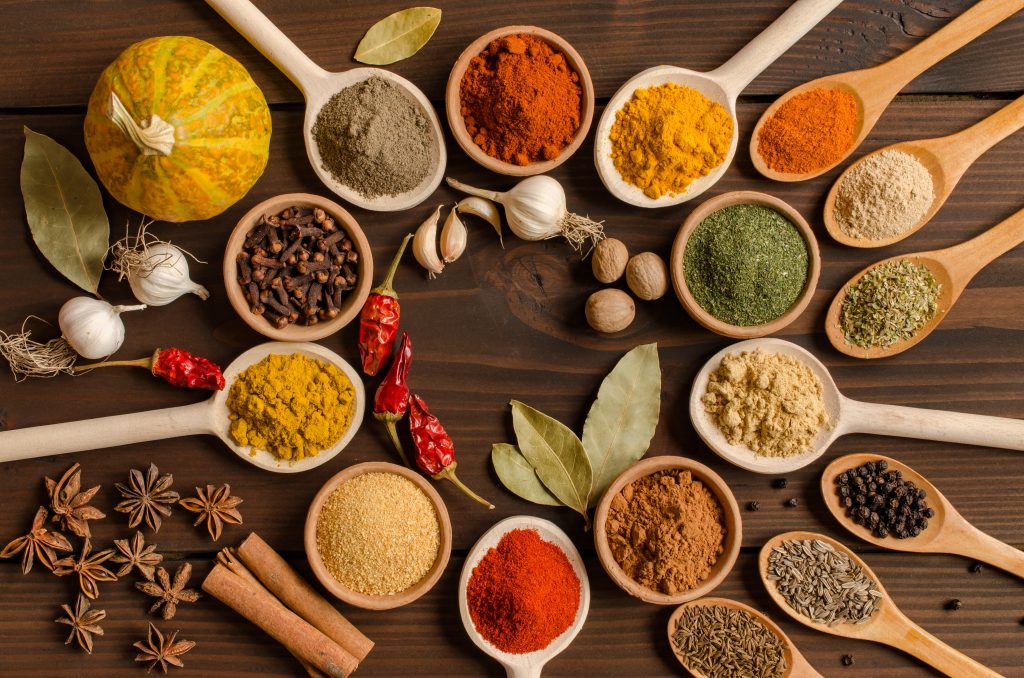 A set of Indian spices on a wooden table