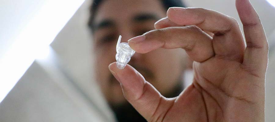 Man is showing the transparent earplug