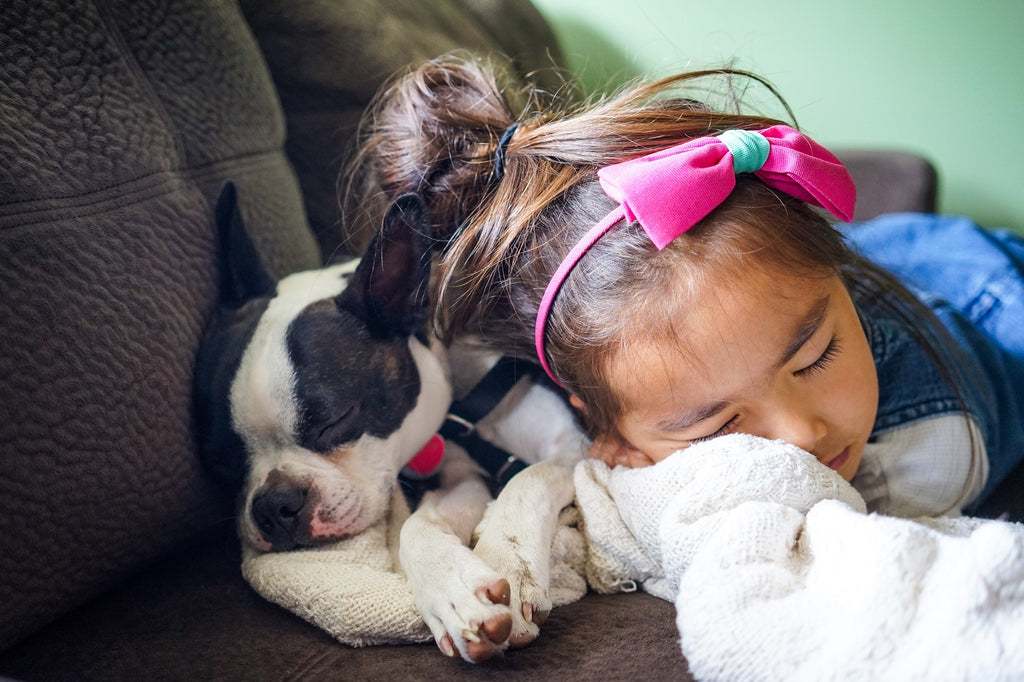 child sleeping with dog