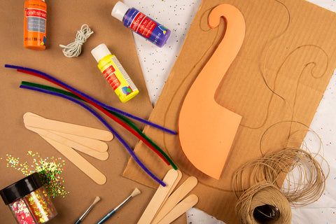 Overhead shot of Mato & Hash Sunday school cardboard and rubber band lyre craft materials