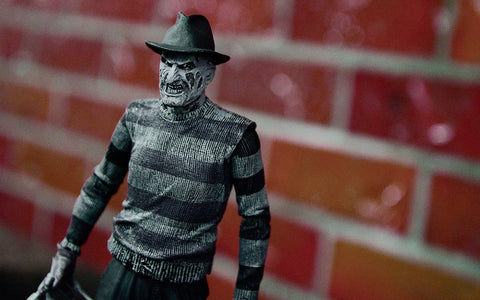 Freddy Krueger Figure Against Brick Background