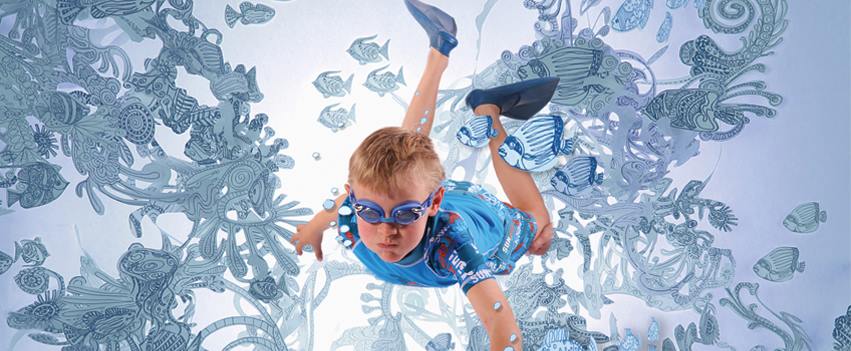 A boy apears to be swimming underwater in bazn swim goggles and swimwear, a graphic design of water is all around him creating a fantasy