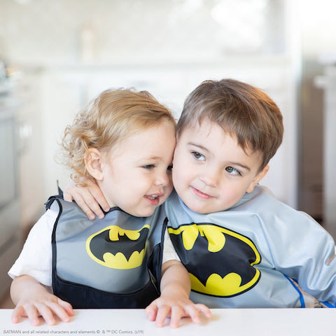 toddlers in matching batman bibs