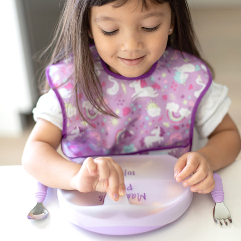 girl opening lid of lavender toddler plate