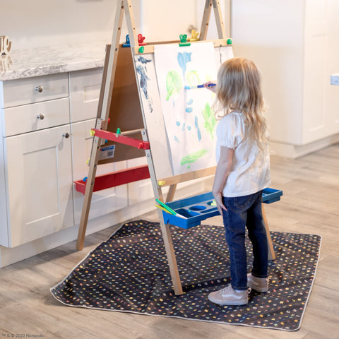 girl painting on top of a super mario splat mat