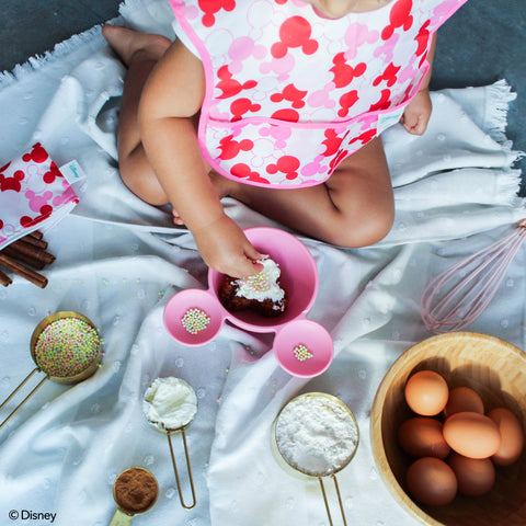 toddler sprinkling cooking ingredients sensory play