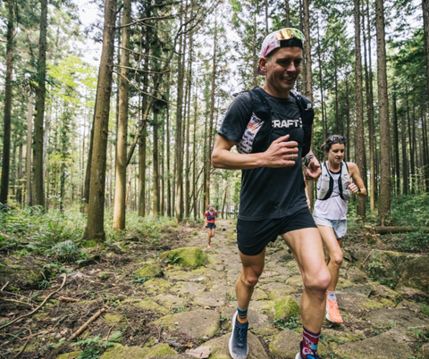 Tim Tollefson running in the woods