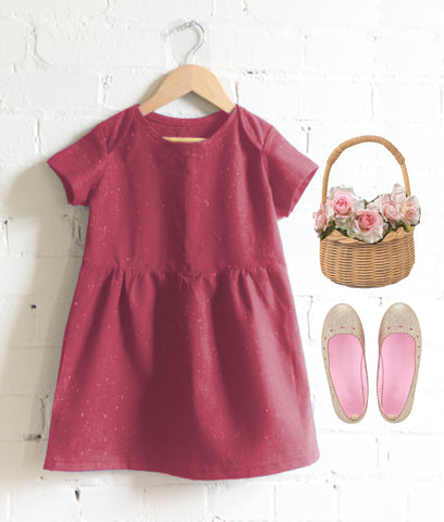 flower girl in pink with flower basket and gold shoes