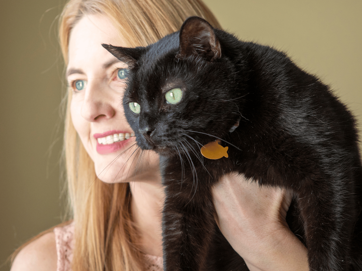 Propriétaire de chat qui donne des antioxydants à son chat atteint du VIF (FIV) pour augmenter son espérance de vie