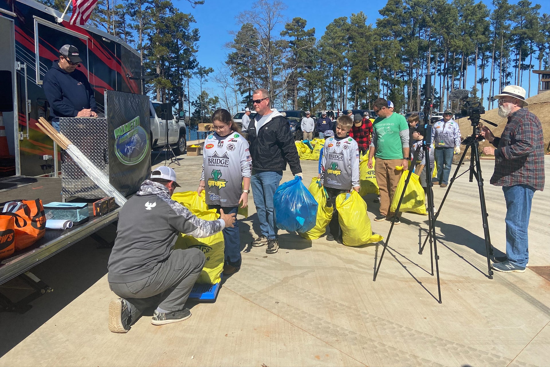 Volunteers in line to throw out AFTCO Bank Bags filled with trash