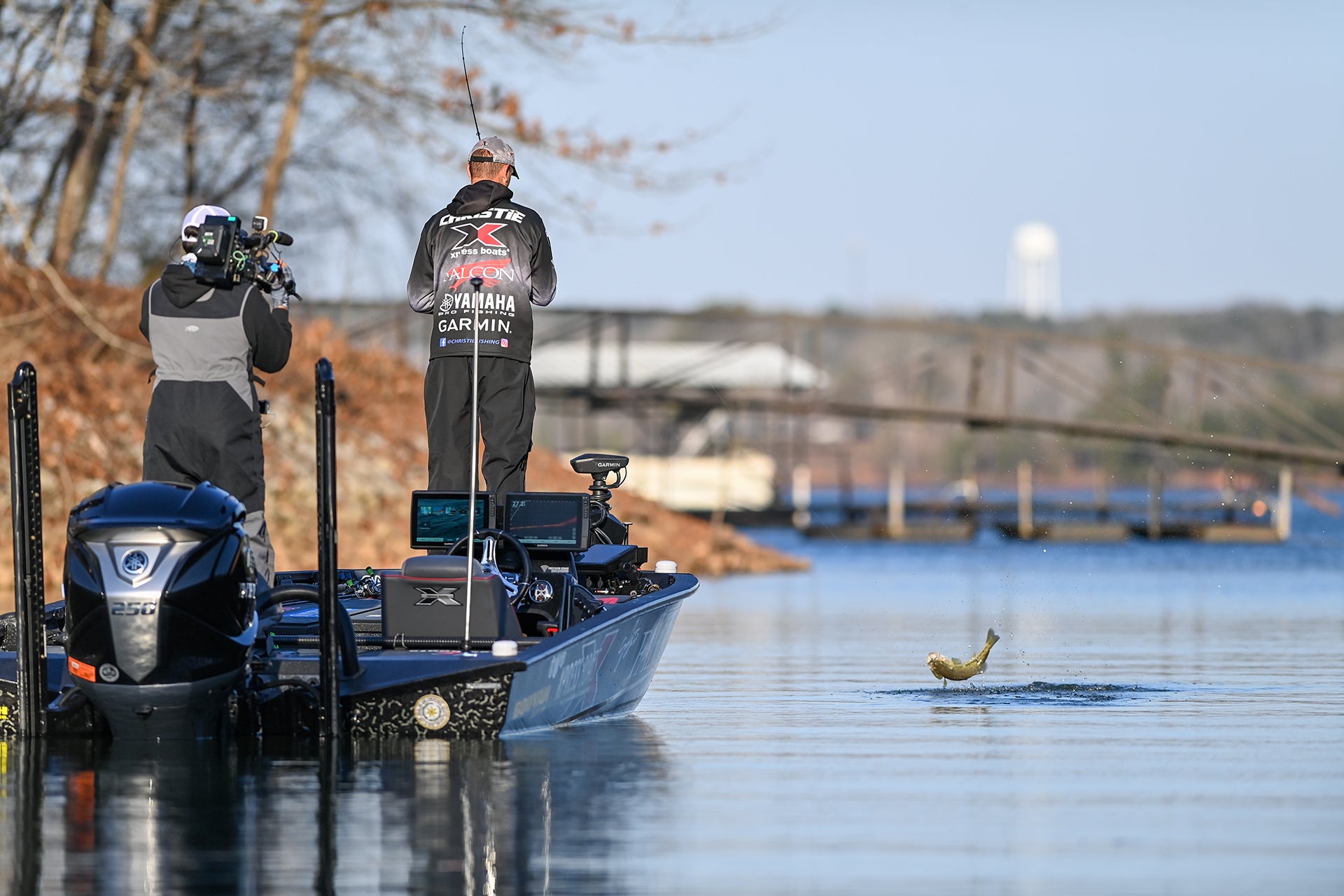 Jason Christie fighting a fish as it jumps out of the water