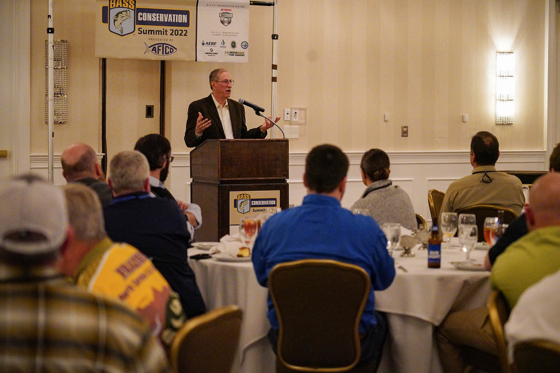 Gene talking to conservation directors at the conservation summit banquet